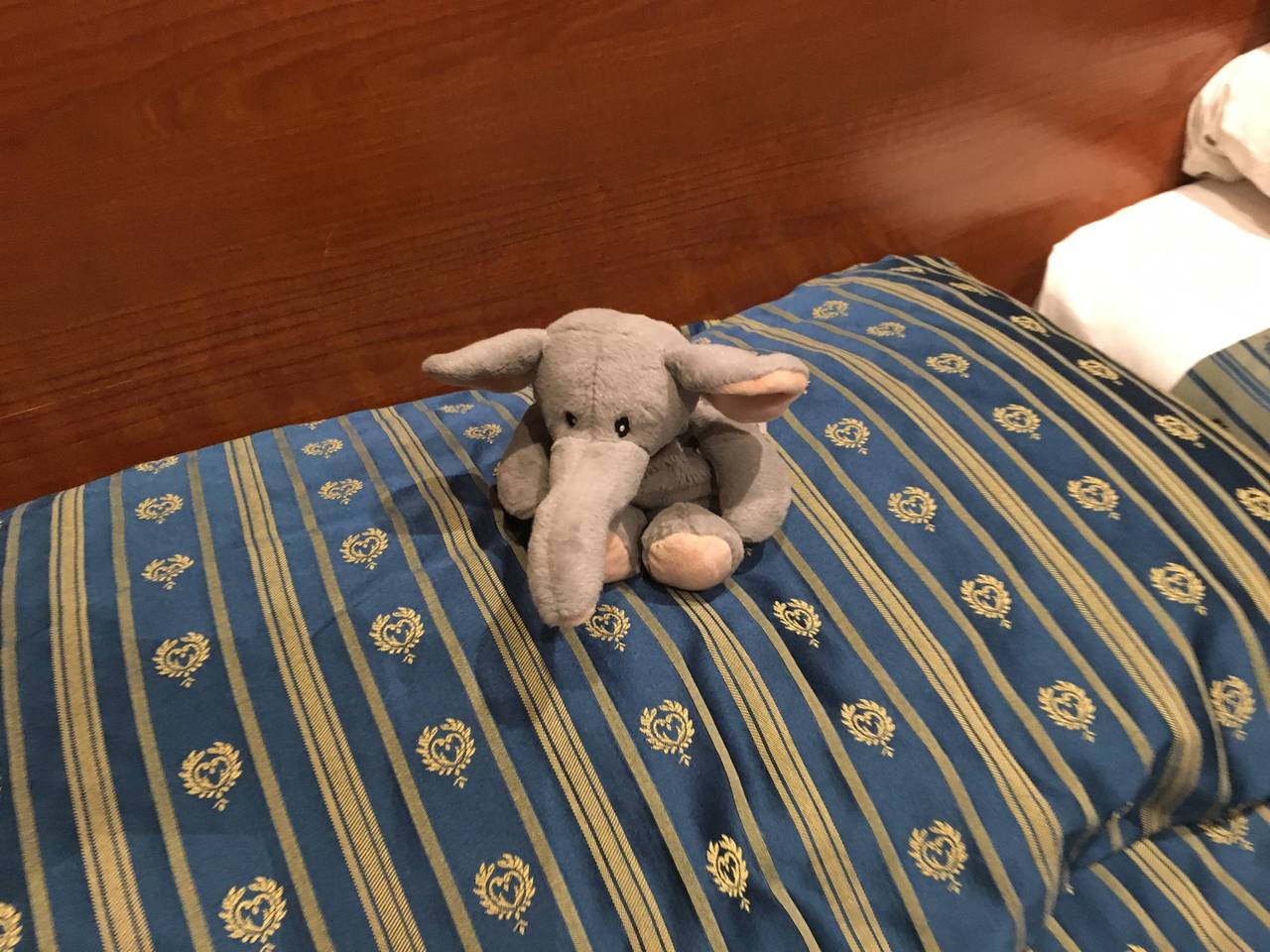 Stuffed elephant sitting on a pillow